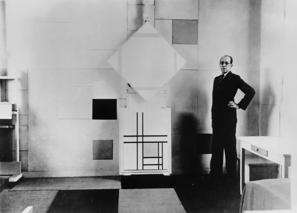 Charles Karsten, Piet Mondrian in his Paris studio with Lozenge Composition with Four Yellow Lines (1933) and Composition with Double Lines and Yellow (1934), October 1933. Collection RKD, Netherlands Institute for Art History via artnet