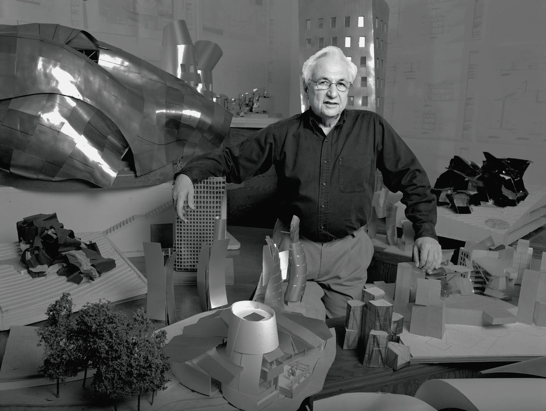 Frank Gehry with miniatures of his designs in Los Angeles, 1989. Photo by Bonnie Schiffman. Via Vanity Fair