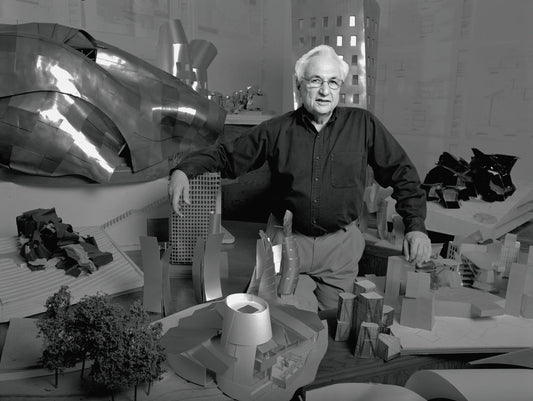 Frank Gehry with miniatures of his designs in Los Angeles, 1989. Photo by Bonnie Schiffman. Via Vanity Fair