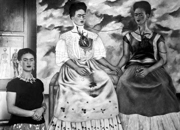 Frida Kahlo pictured with her work, Two Fridas, 1939 via Fridakahlo.org