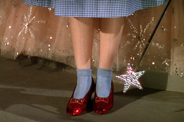 Judy Garland wearing the original red ruby slippers in The Wizard of Oz via Rolling Stone